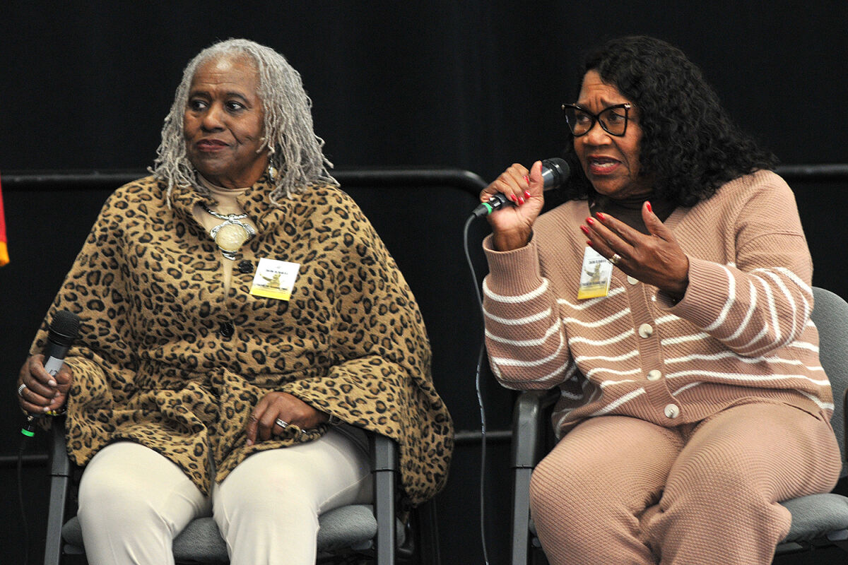  Sisters Alice Moore and Denise Jarnigan-Holt, holding microphone, answer questions during a panel discussion. Moore and Jarnigan-Holt began their involvement in the civil rights movement at the ages of 16 and 14 when they joined John Lewis and the Student Nonviolent Coordinating Committee. 