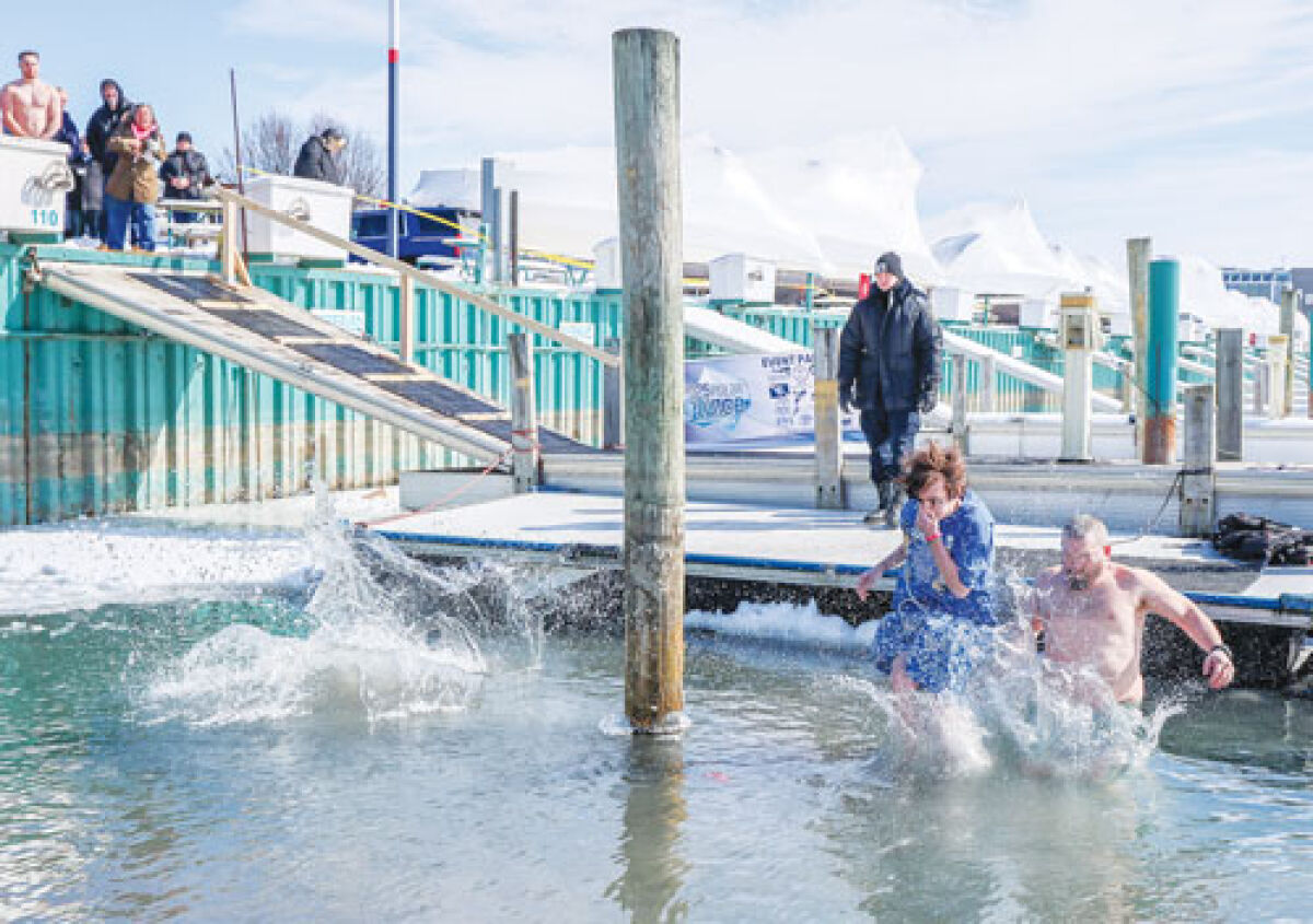  Participants at the Macomb County Polar Plunge leap into freezing cold water to raise money for a good cause.  