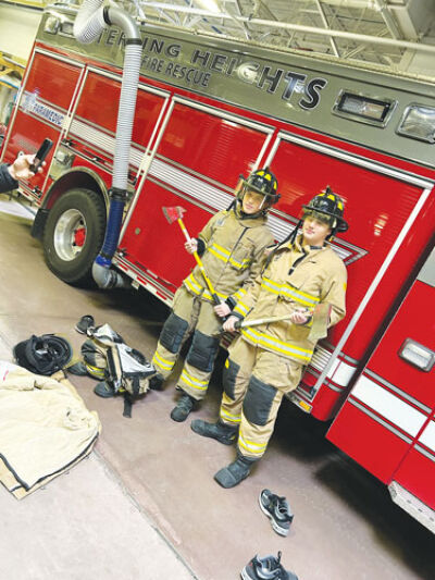  Henry Ford II High School students Max Brinker, left, and Alex Oxie try on firefighting gear. 