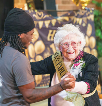  Arbor Inn caregiver Brandon Griffin, left, dances with resident Eleanor Stepanski as she celebrates her 100th birthday. 
