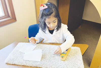  A student uses an independent workstation to learn math concepts at Country Hills Montessori in Farmington Hills. 
