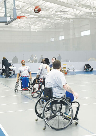  Players watch a shot in a game of basketball during the 2025 Adaptive Recreation Experience. 