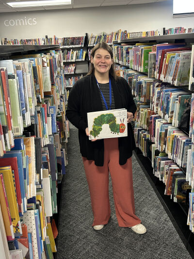  Anneliese White, public relations and programs coordinator for the Sterling Heights Public Library, is the city’s 2025 Employee of the Year. The book she’s holding, “The Very Hungry Caterpillar,” inadvertently led to her job at the library. 