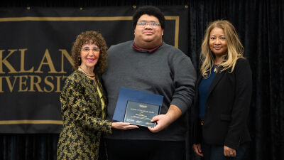  From left, Oakland University President Ora Hirsch Pescovitz, Marcus Johnson and Vice President of Inclusion, Engagement and Strategic Partnerships at Comerica Bank Wendy Holmes pose for a picture at the Oakland University Keeper of the Dream Scholarship Award Ceremony Jan. 19 in Rochester. 