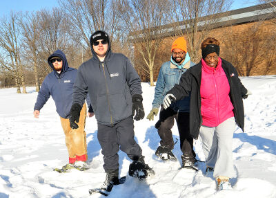  Southfield resident Lillie Smith, right, tries taking a walk in snowshoes along with Oakland County Parks and Recreation employees, from left, Aiden Watson, Christian Meredith and Cesante Ward. 