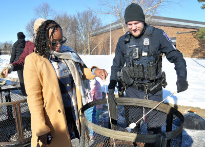  Dominique Johnson and Southfield Police Sgt. Lawrence Tomasino roast marshmallows at the Southfield Winter Fest on Feb. 1. 