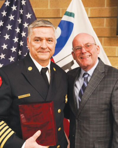  Fire Chief Kevin Edmond, left, Sterling Heights’ Administrator of the Year, stands with City Manager Kevin Vanderpool.  