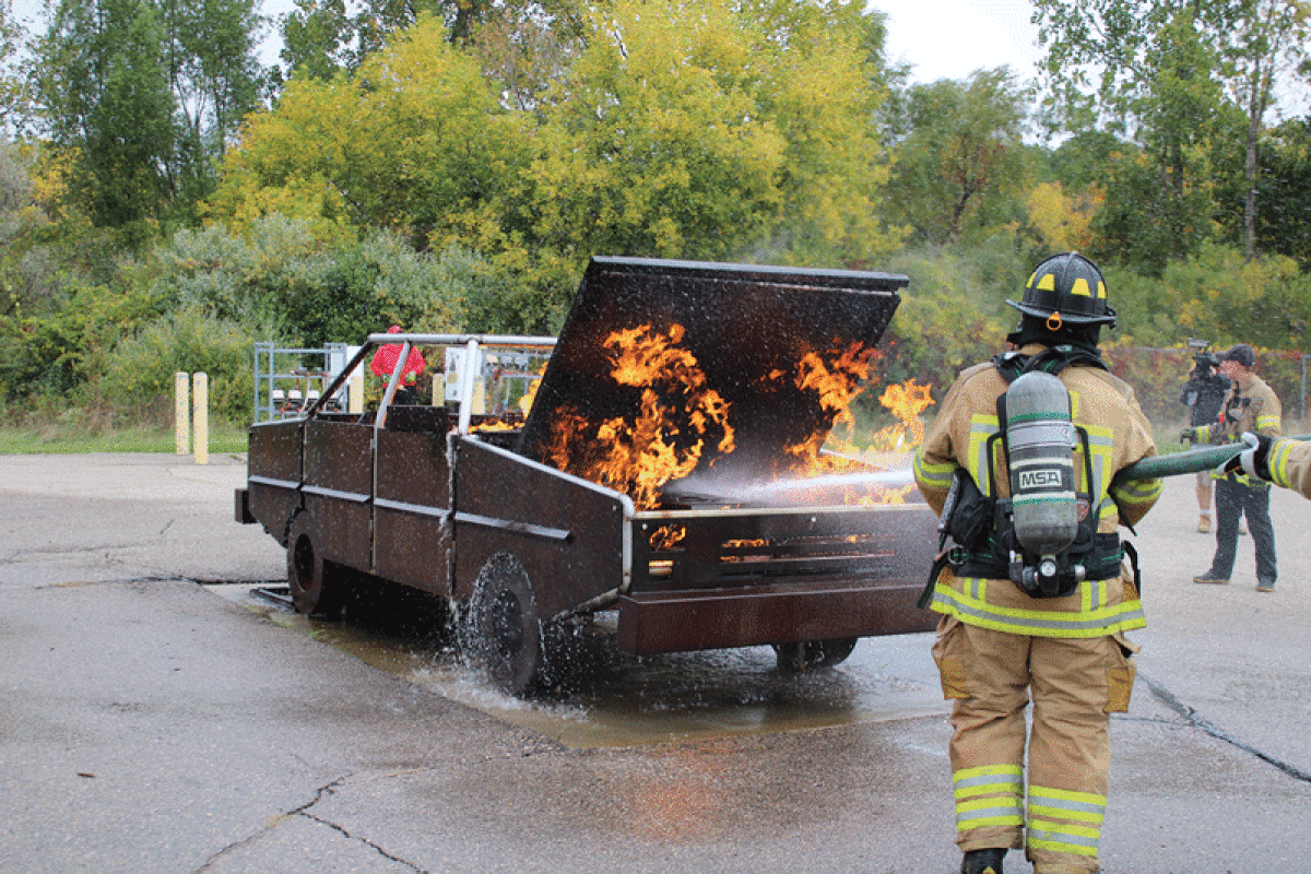  Participants at the Fire Ops 101 event learn how to put out a car fire.  