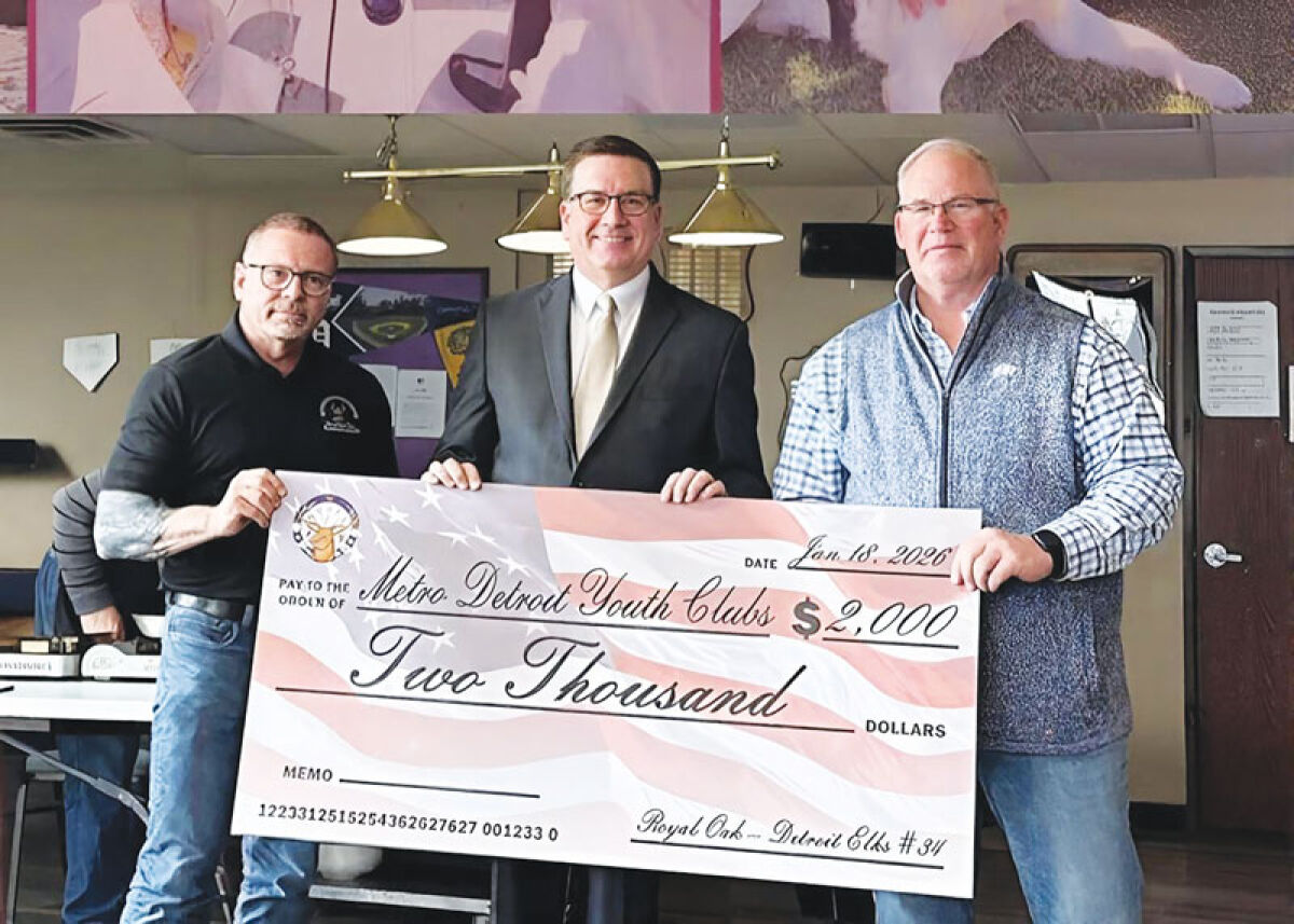  Mike Barolotta, Brett Tillander and Jim Flanigan, of Metro Detroit Youth Clubs, pose for a picture.  