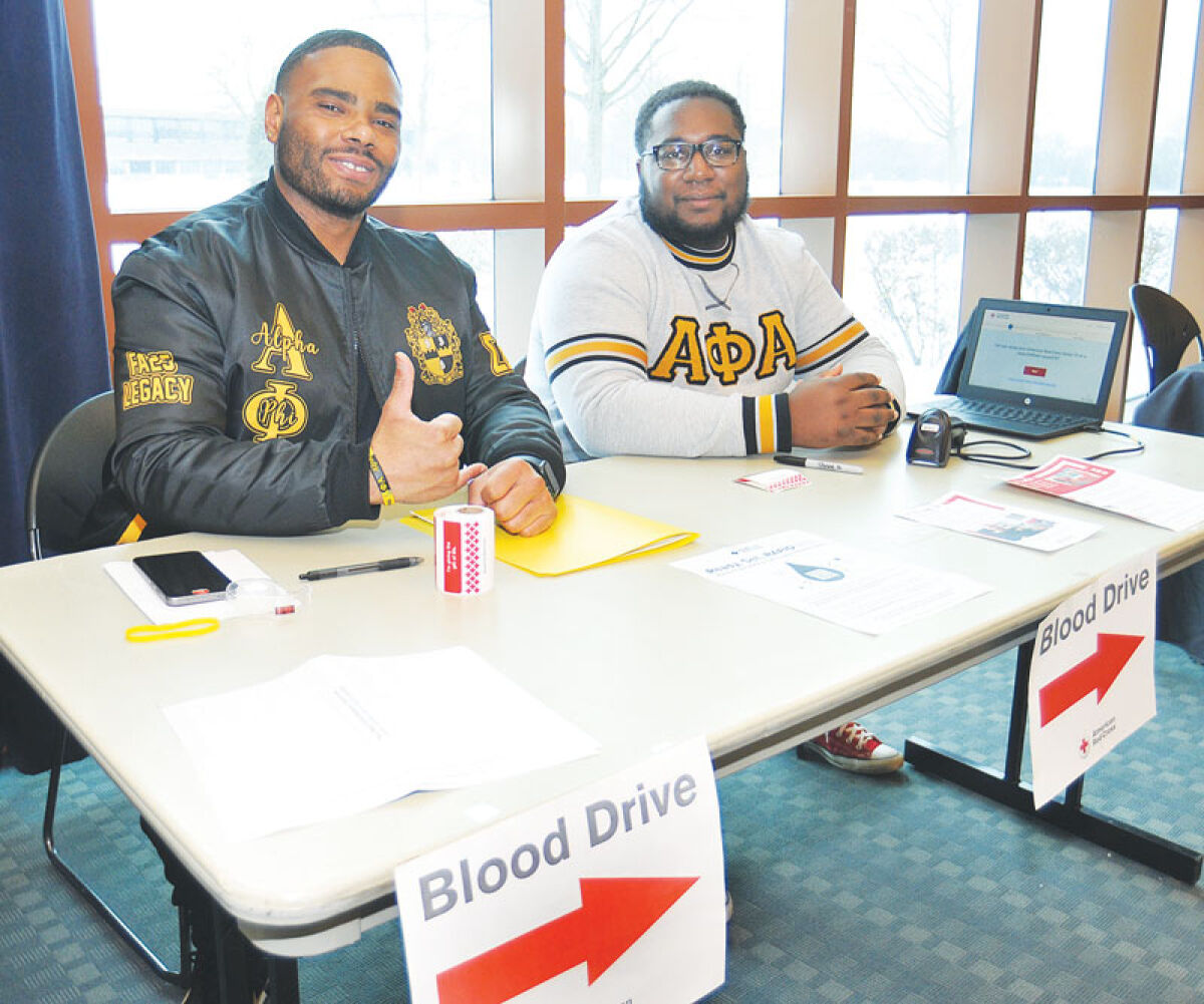  Derrick Jones ll, left, and JonDareo Northington Sr., of the Alpha Phi Alpha Fraternity Inc., Sigma Delta Lambda Chapter, help out at the Red Cross’ blood drive at the Southfield Library on Feb. 2. 