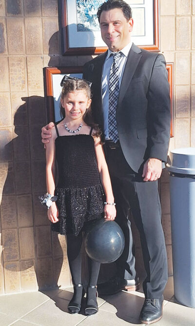  Frank D’Angelo and his daughter, Briar, 7 1/2, pose for a photo after the 2 p.m. daddy-daughter dance at the Novi Civic Center on Feb. 7. 