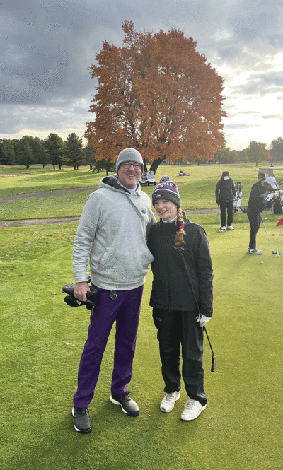  Bloomfield Hills girls golf coach Brendan Harrington stands with senior Brooke Bugajewski. 