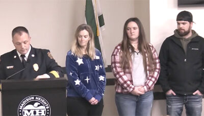  Madison Heights Deputy Fire Chief Ray Gilson reads the commendations for citizens Laura Schultz, Harley James and Steven Crane, who were recognized with a Civilian Citation for their role rescuing an occupant from a structure fire shortly before Christmas. 