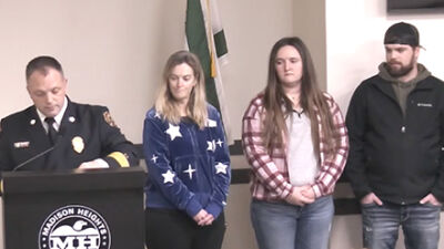  Madison Heights Deputy Fire Chief Ray Gilson reads the commendations for citizens Laura Schultz, Harley James and Steven Crane, who were recognized with a Civilian Citation for their role rescuing an occupant from a structure fire shortly before Christmas. 