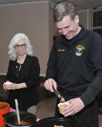  Sharing is Caring Aid President Kim Steelman, left, and Lathrup Village Police Chief Michael Zang get bowls of chili at the fifth annual Lathrup Village Police Department chili dinner on Feb. 12. 