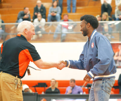  Olympian Freddie Crittenden receives his Hall of Fame plaque from Utica High School Principal Tim Youngblood. 