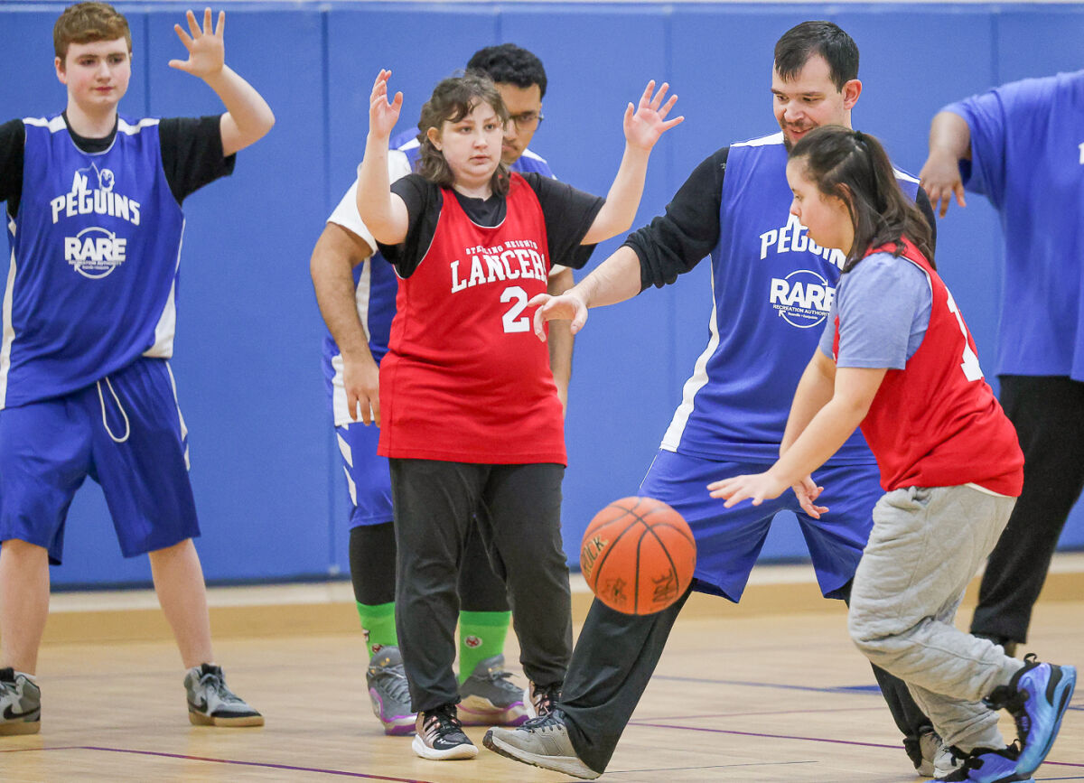  The Sterling Heights Lancers, in red, traveled on Feb. 12 to the Recreation Authority of Roseville and Eastpointe building in Roseville to face the RARE Penguins, in blue, in the Adaptive Basketball League.  