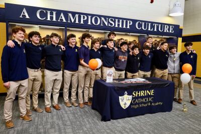 Alba celebrates his commitment with his Shrine teammates after making the signing official.