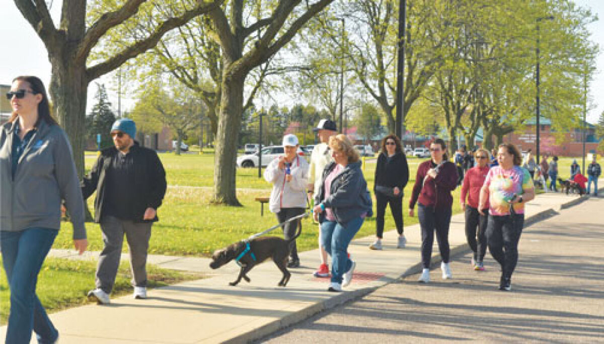  People walk in a past Macomb Community Action Walk for Warmth event near the Juvenile Justice Center. The 2026 Walk for Warmth will take place on Saturday, Feb. 28 in Mount Clemens. 