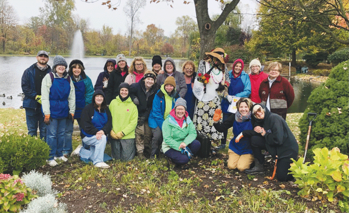  The Shelby Gardeners Club gathers around its entry in Shelby Township’s scarecrow contest, which put the scarecrows around Heritage Lake on the township municipal grounds. The scarecrow Thor, by World of Floors, won the contest.  