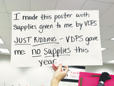  Several Van Dyke Public Schools teachers held up signs to show their frustration over a decision about their contracts.  