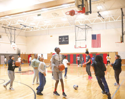  Instead of playing on their cellphones, a group of Lincoln Middle School students play basketball in the gymnasium  Feb. 18 during lunch. On Feb. 10, Gov. Gretchen Whitmer signed two  legislative bills into law that call for Michigan school districts to  create action plans to keep cellphones out of the classroom.  Lincoln Middle School is already doing that.  