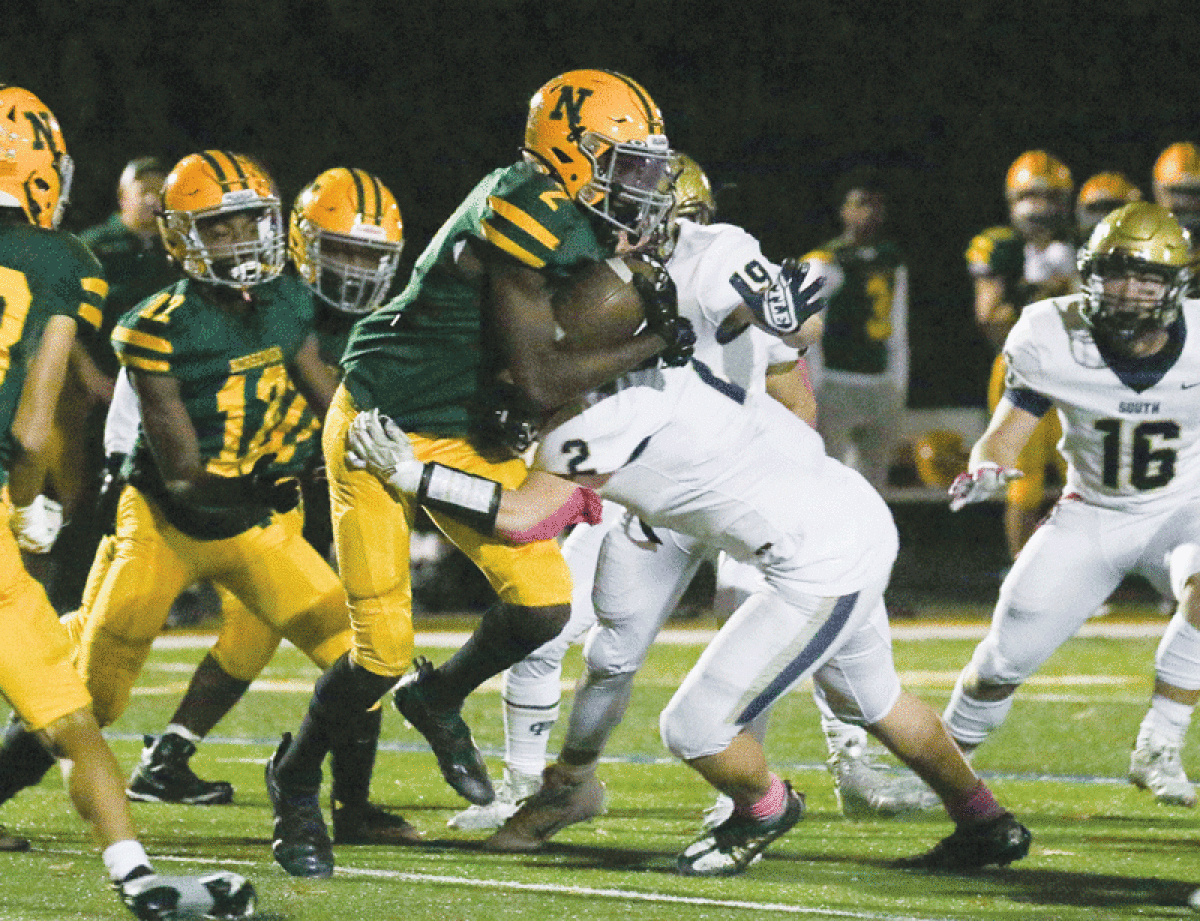  Grosse Pointe North senior Jayden Holyfield carries the ball against Grosse Pointe South on Oct. 21 at Grosse Pointe North High School. 
