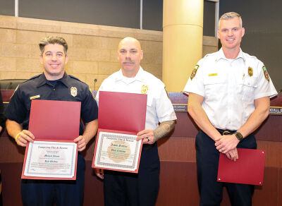  Eastpointe Fire Chief Jason Clark, right, presents unit citations to firefighter Michael Adamo, left, and Battalion Chief Jason Frattini at the Feb. 17 City Council meeting. 