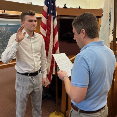  New Grosse Pointe Farms Public Safety officer Seth Locklear is sworn in Feb. 18 by Farms Assistant City Manager/City Clerk Derrick Kozicki. 