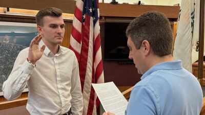  New Grosse Pointe Farms Public Safety officer Seth Locklear is sworn in Feb. 18 by Farms Assistant City Manager/City Clerk Derrick Kozicki. 