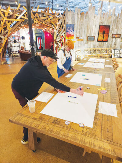 Scott Sprague and Amy Wipp participate  in a public information session during last year’s Art March. Another meeting like  this will be held this year. 