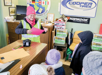  Karen Krausmann, of the Krausmann Service Station, accepts a handmade valentine from a Maire student. She’s also a crossing guard at the intersection of Kercheval Avenue and Cadieux Road, a Krausmann family tradition for many years. 