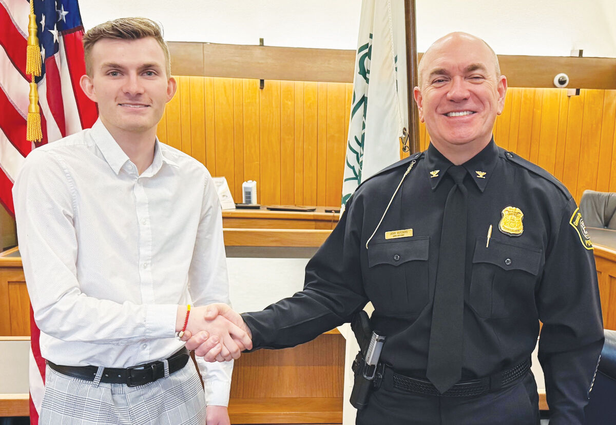  From left, new Grosse Pointe Farms Public Safety officer Seth Locklear shakes hands with Public Safety Director John Hutchins after he’s sworn in Feb. 18 in Farms City Council chambers. 