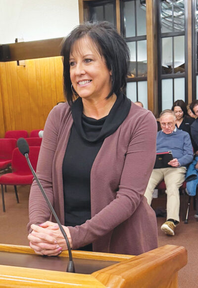  Grosse Pointe Farms Deputy Treasurer Michelle Hoch listens as Mayor John Gillooly highlights her accomplishments during a Feb. 9 Farms City Council meeting. 