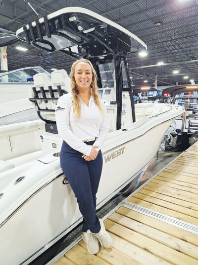  Kayla Rossow, of Anderson’s Boat Sales in Harrison Township, stands beside a Key West Boat. 