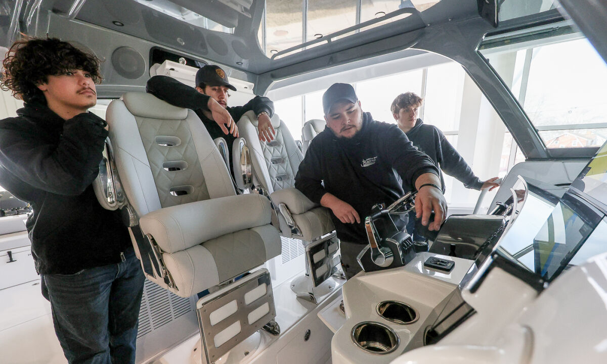   Jefferson Beach Yacht Sales marine technician Vince Fisher takes Utica Community Schools students all around an HCB Yacht and its cabin electronics Feb. 26 in St. Clair Shores.  