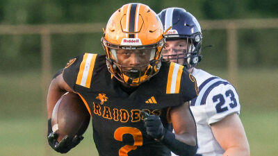  Leland Holingsworth, of North Farmington High School, breaks off a run against Livonia Stevenson in a 2025 matchup. 