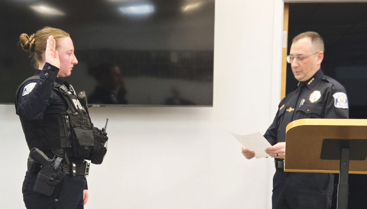  Farmington Public Safety Director Robert Houhanisin, right, swears in his department’s latest  public safety officer, Erin Moylan, at the Farmington City Council meeting Feb. 17.  