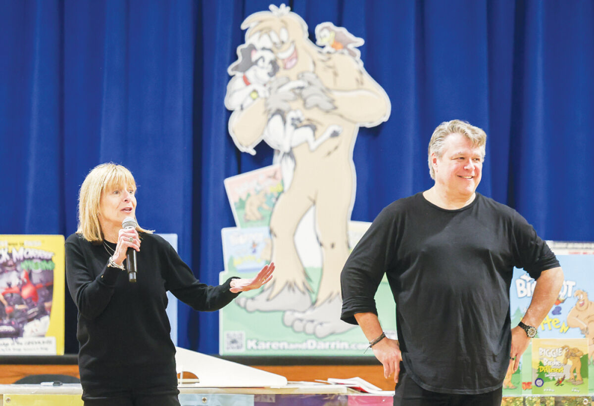  Karen Bell-Brege, left, and Darrin Brege share their love of reading, writing and illustrating with students at Black Elementary School Feb. 27.The husband-and-wife duo have published several books over the years, including the “Mick Morris Myth Solver” books and the “Ghost Board Posse” series.  