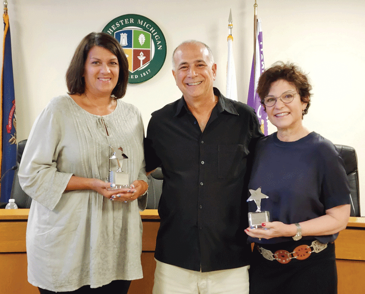  Rennee Perkins, left, and Linda Gallaher, right, were recently presented with the first  Bill Lipuma Community Spirit Award by Tony Lipuma, center.  