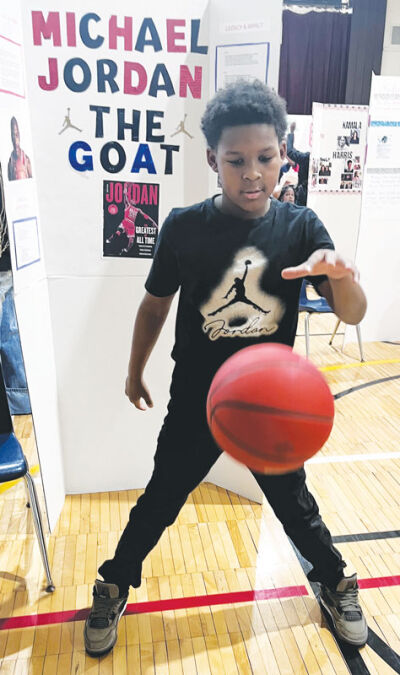  Fifth gader Zyir Davenport gets into character as retired Chicago Bulls basketball star Michael Jordan. 