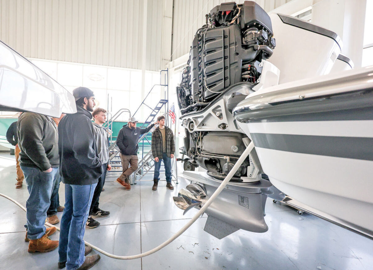  Students with the Utica Community Schools career and technical education small engine program shadow marine technicians as they learn about different mechanical needs for watercraft. 
