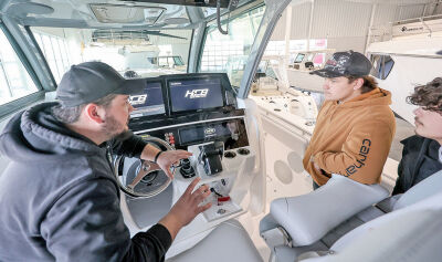  Marine technician Vince Fisher teaches Cole Stark and Lander Traub, students with the Utica Community Schools career and technical education small engine program, was able to learn from marine technicians from Jefferson Beach Yacht Sales and Colony Marine about the marine technician career path. 