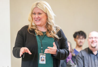  UCS school board President Mary Smolenski addresses students and teachers involved in collecting the food. 