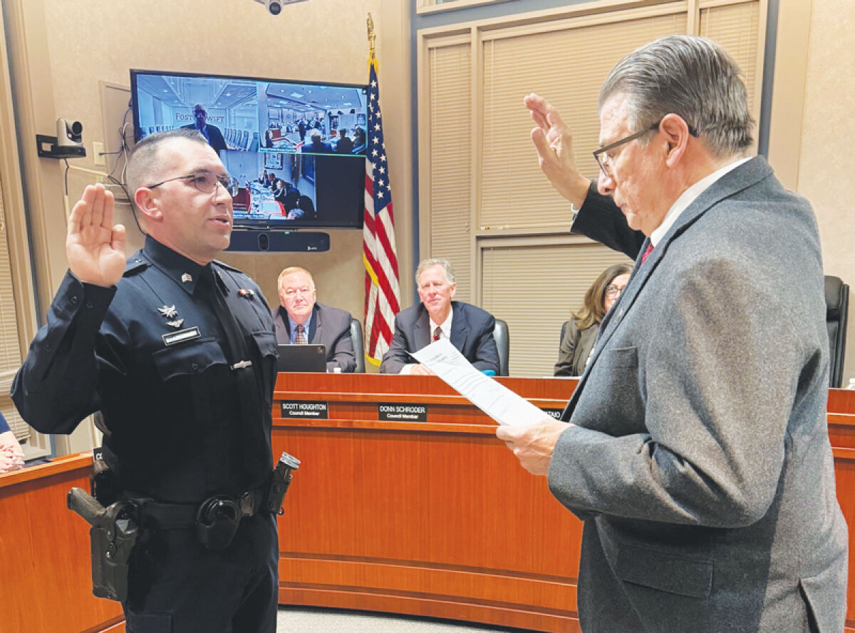  Newly minted Grosse Pointe Shores Public Safety Sgt. Jeff Roybal is sworn in by Mayor Ted Kedzierski during a Jan. 20 Shores City Council meeting. 