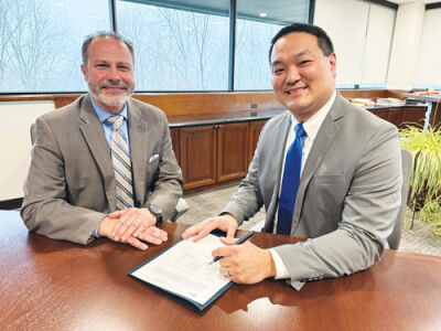  RCS Superintendent Nicholas Russo and Assistant Superintendent of Business Operations Matthew McDaniel sign paperwork. 