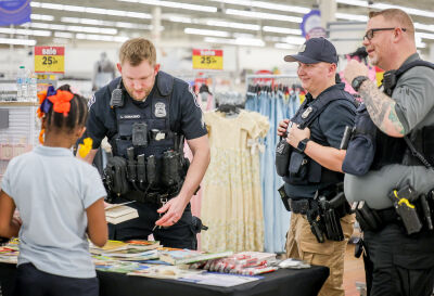 Tomasino, Simon and Hendricks hand out gently used children's books in conjunction with Reading Month on March 10 at Meijer on Telegraph Road.. 