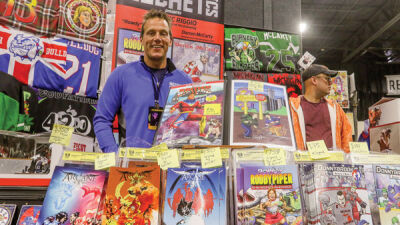  Writer Dominic Riggio, of Birmingham, displays the work he does through his business, Mess Bucket Comics, at Motor City Comic Con Oct. 14-16. One of his comics series is based on his time playing junior hockey, and one of the comics features a story based on his experiences with former Detroit Red Wing Darren McCarty. 