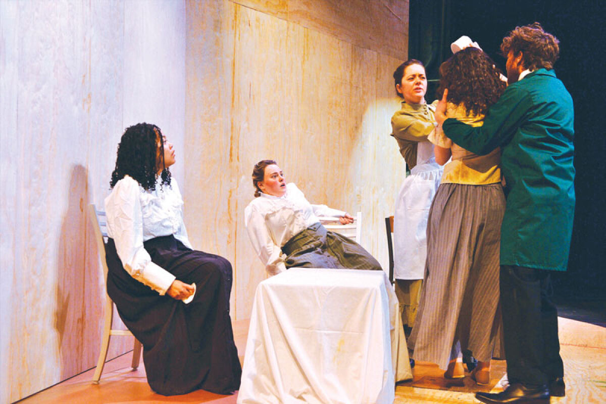  Members of the Oakland Community College cast of “Mrs. Packard” rehearse a scene during a dress rehearsal. Pictured from left are Rosa Mills (Mrs. Chapman), Kat Isrow (Elizabeth Packard), Julie Kline (Lizzie Bonnor), Adrianna Sagmani (patient) and Brayden Hill (orderly). 
