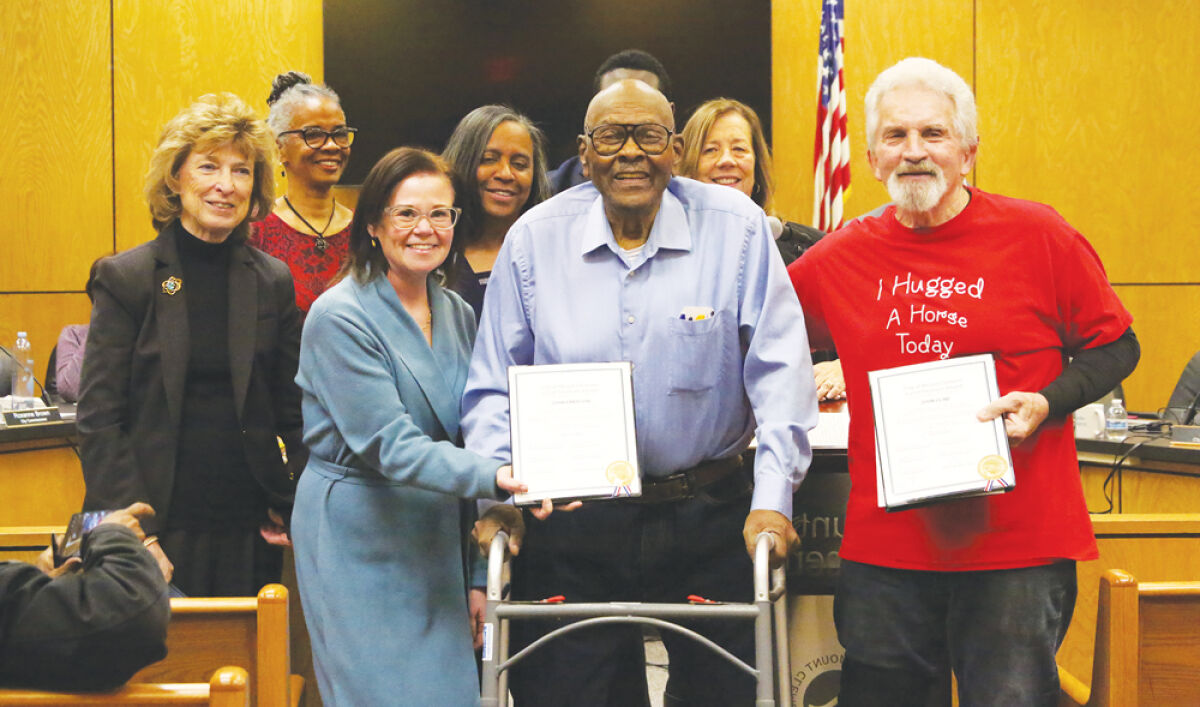 The Mount Clemens City Commission poses for a photo with Local Treasure Award recipients John Emerson,  in middle with glasses and blue shirt, and John Cline, in red shirt, on March 16. 